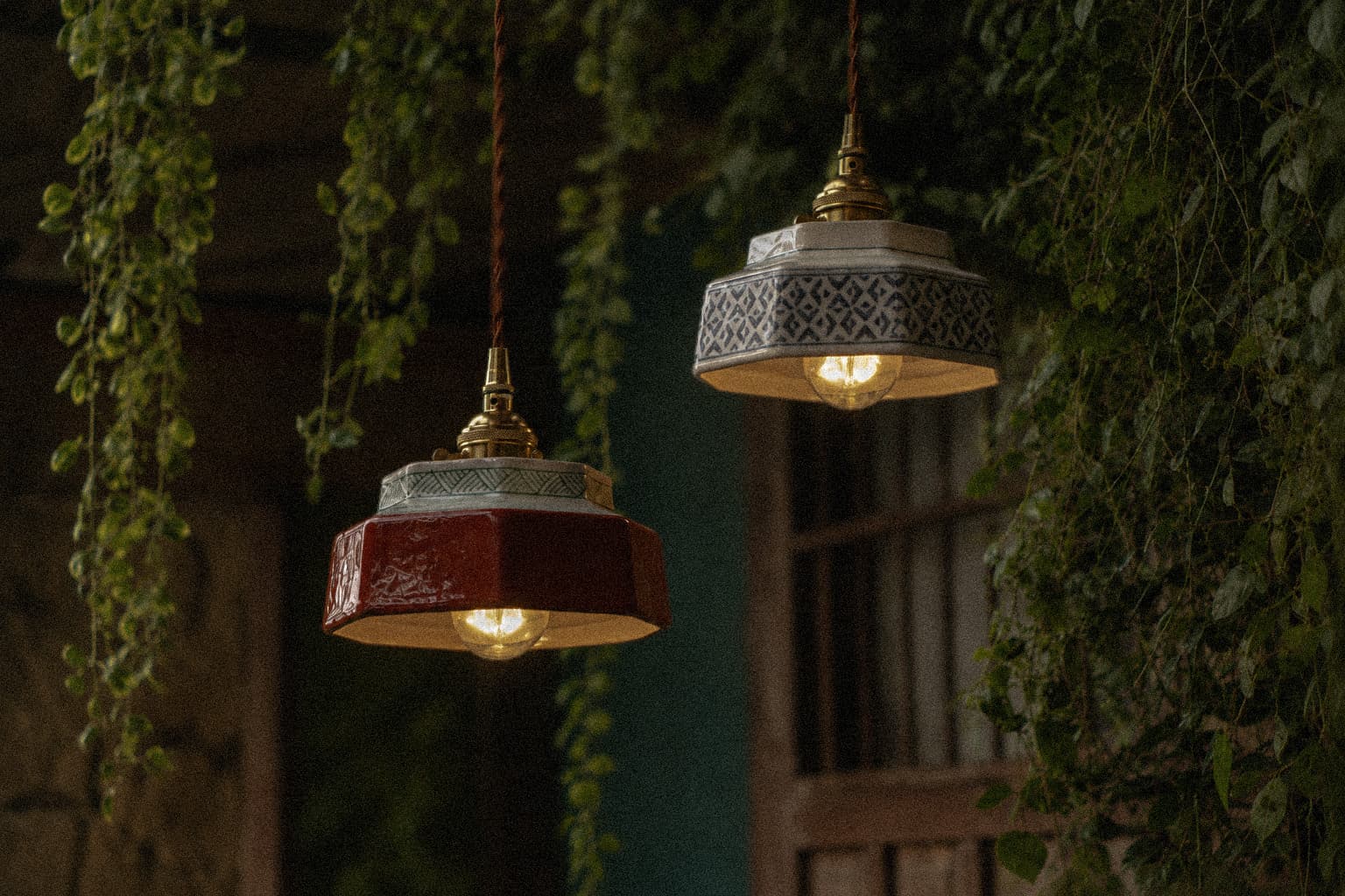 Ceramic pendant lights surrounded by greenery